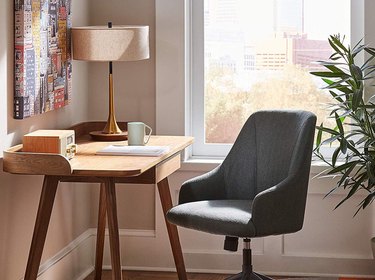 desk space with gold midcentury modern lamp