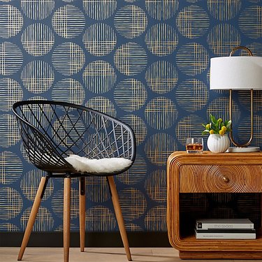 Midcentury modern wallpaper with cross hatch circles in blue and gold