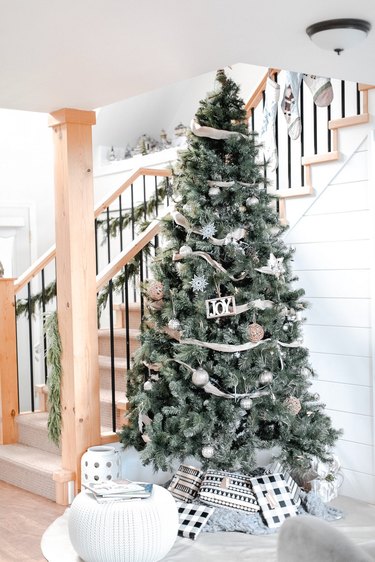 Modern  farmhouse Christmas decorating idea with tree with ornaments and wrapped gifts