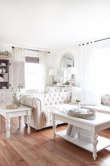 feminine farmhouse-style living room with window-frame mirror