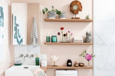 Floating shelves around your sink provide easy access to all your self-care needs.