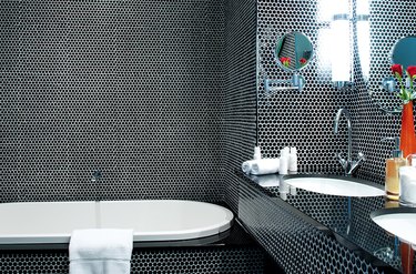 Black bathroom backsplash idea with floor to ceiling penny round tile