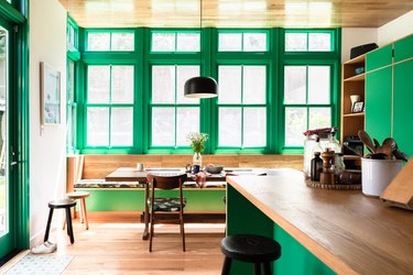 kitchen with green cabinets and trim and wooden countertops