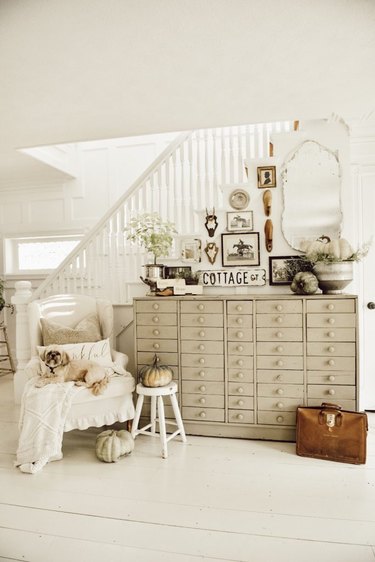 vintage farmhouse decorating idea at entryway with vintage gallery wall and light colors