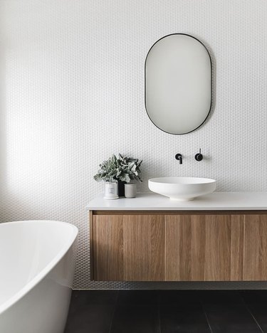 penny tile bathroom backsplash idea with white grout in modern bathroom