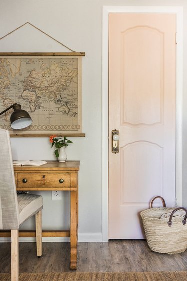 vintage farmhouse decorating idea with pink bedroom door and vintage map