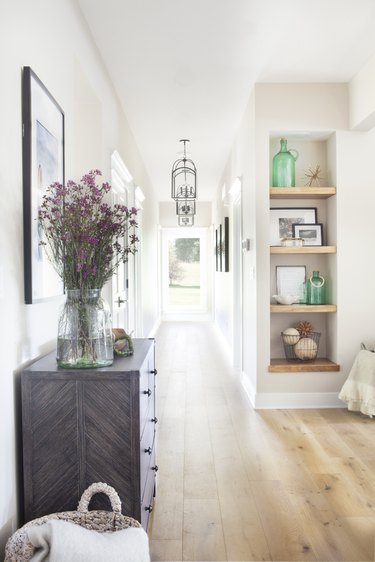 vintage farmhouse decorating idea at entryway with weathered woods and light finishes