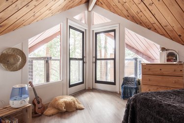 bedroom with oak flooring and wide windows