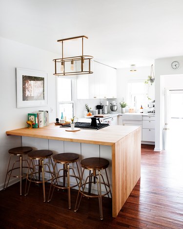 kitchen bar idea with wooden countertops in simple kitchen with wood and copper bar stools