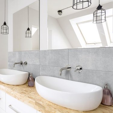 bathroom backsplash idea with oversize tile behind vessel sinks