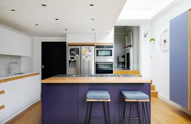 purple kitchen color idea with wooden countertops and stainless steel appliances