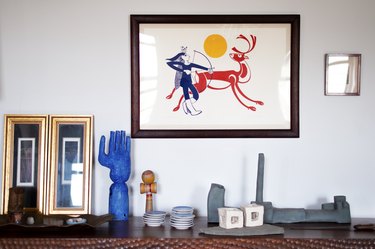 decorative objects on cabinet and framed artwork on the wall
