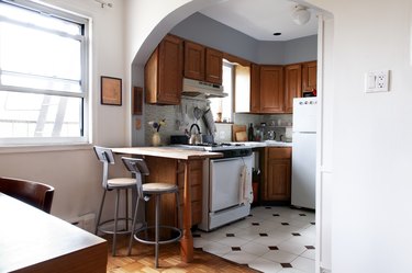 small kitchen open to dining room with an arch