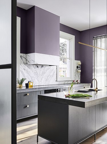 purple kitchen color idea with black cabinetry and marble backsplash