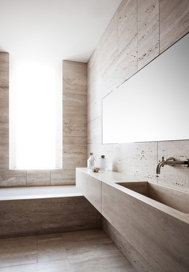Floor to ceiling travertine bathroom with minimalist accents