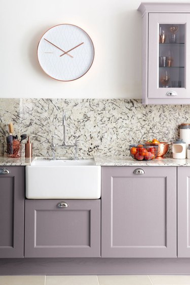 purple kitchen color idea with marble backsplash and farmhouse sink