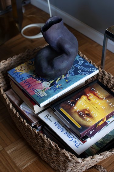 basket with books and sculpture
