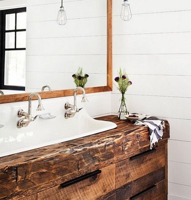 Shiplap and reclaimed wood tie this vanity and backsplash together forever.