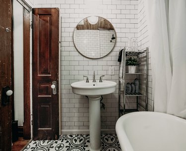 Tiled floor in a small bathroom with white tile walls