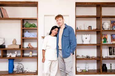 two figures standing near shelves