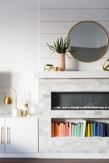 white living room with electric fireplace and niche for books