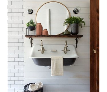 Farmhouse sink with a rustic wood shelf under a Target Project 62 round shelf.