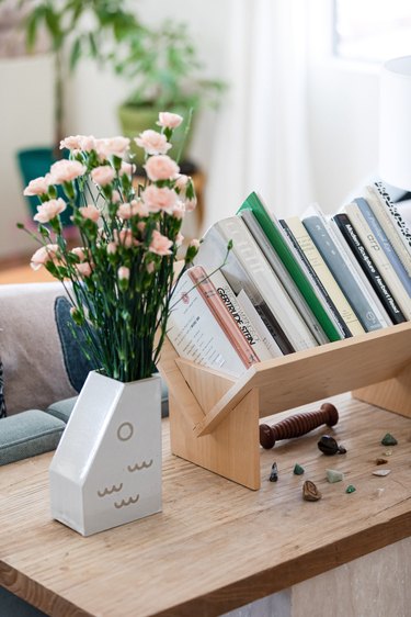 vase with flower and books nearby