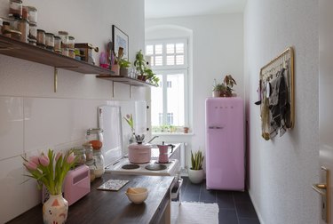 kitchen with brown cabinets and pink appliances