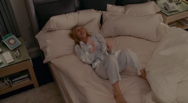 kate winslet playing air guitar in bed, still image from the holiday