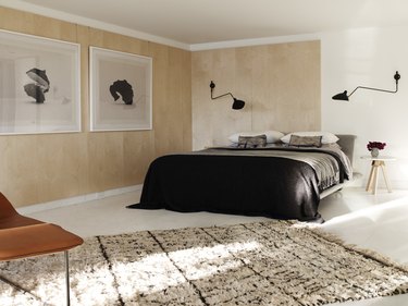 modern beige bedroom with wood paneled walls and area rug