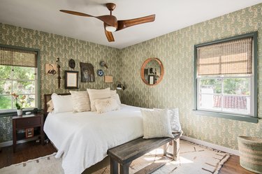 bedroom color idea with sage green patterned wallpaper and wooden ceiling fan