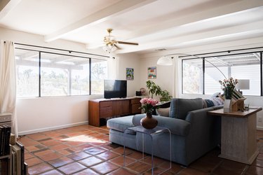 living room with white beams and blue couch