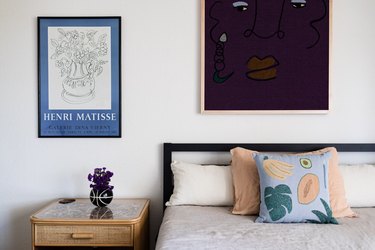 bedroom with framed artwork on the walls