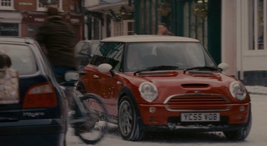red mini cooper driving around, still image from the holiday
