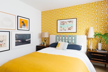 yellow accent wall and blanket in bedroom