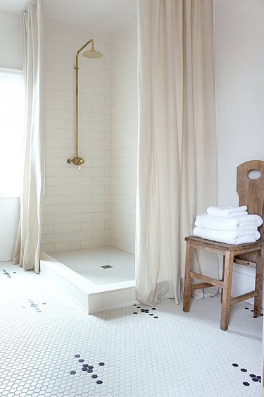 White bathroom with black and white mosaic bathroom floor tile