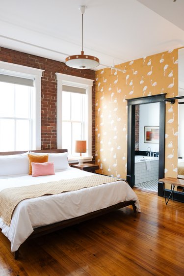 industrial bedroom with yellow wallpaper