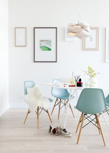 modern white dining room with blue chairs