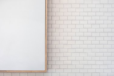 focus on mirror against white subway tile wall