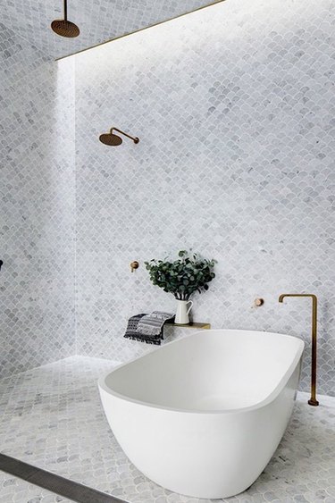 modern walk-in bathtub shower combination with mosaic tile wall and floor
