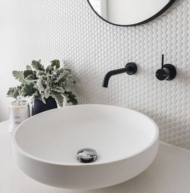 Round bowl sink, black Wall-Mounted Bathroom Faucet, hectagonal backsplash.