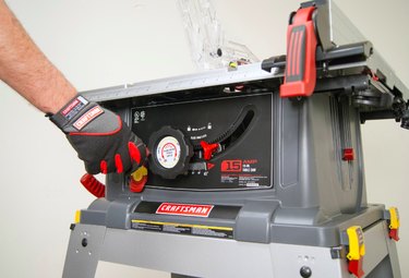 Adjusting a table saw.