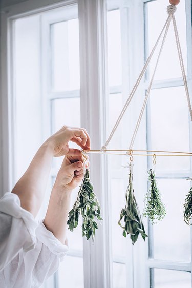 Attaching herbs to DIY Herb Drying Rack