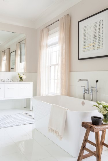 neutral toned bathroom with freestanding tub and modern fixtures