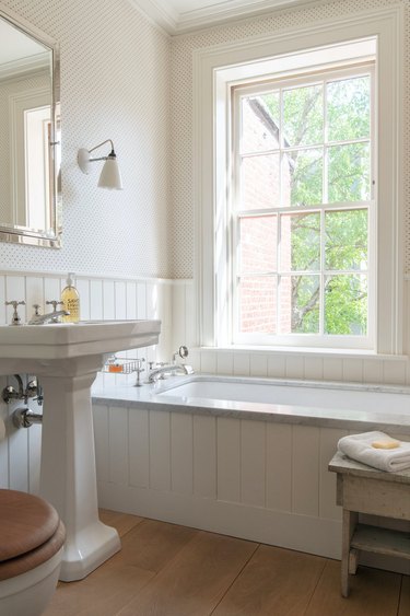 bathroom tub backsplash idea with wood-panelling around drop-in tub