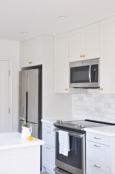 kitchen space with white and light gray cabinets