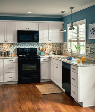 kitchen space with white cabinets and blue walls