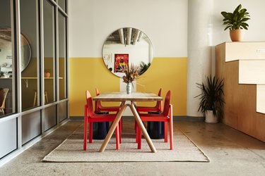 Photograph of yellow space with red chairs