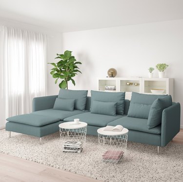 scandinavian-style living room with blue-green sofa