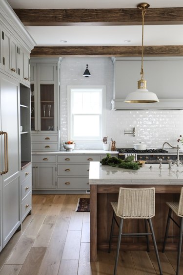 traditional kitchen with white tile backsplash and pendant light